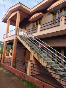 a building with stairs on the side of it at Hidden gem home stay in Madikeri