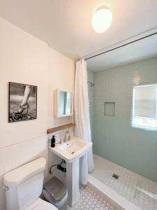 a white bathroom with a sink and a toilet at Newly remodeled 1 bed, 1 bath home near LAX, Forum in Inglewood