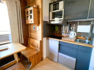 a small kitchen with a sink and a stove at Studio Tignes, 1 pièce, 2 personnes - FR-1-502-317 in Tignes