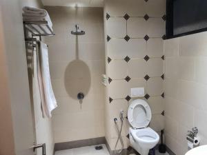 a small bathroom with a toilet and a shower at The Perfect Getaway @ Tamarind Suites, Netflix 300Mbps in Cyberjaya