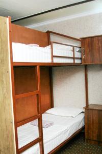 a bunk bed with two bunk beds in a room at Guest House Evergreen in Margilan