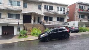 a black car parked in front of a house at Montreal Downtown Suite in Montréal