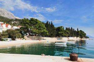 a beach with two boats in the water at Apartments by the sea Zivogosce - Mala Duba, Makarska - 18626 in Igrane