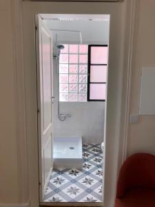 een kleine badkamer met een raam en een tegelvloer bij Angels Homes-n27, 3ºfloor - Bairro Típico, Centro Lisboa in Lissabon