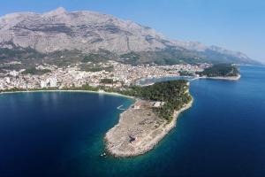 an island in the middle of a body of water at Apartments by the sea Makarska - 19145 in Makarska