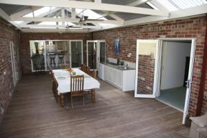 a kitchen and dining room with a table and chairs at Cabarita Lodge in Mildura