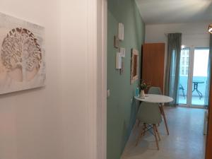 a hallway with a table and a room with green walls at Lucky Suite in Heraklio
