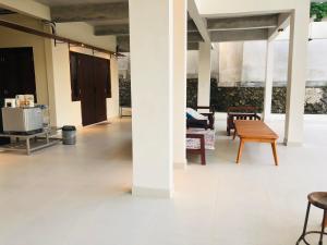a room with chairs and a table and a bench at passifika house in Canggu