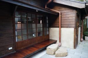 a wooden entrance to a building with a door at 南庄東村宿舍Nanzhuang Dongchon Homestay in Nanzhuang