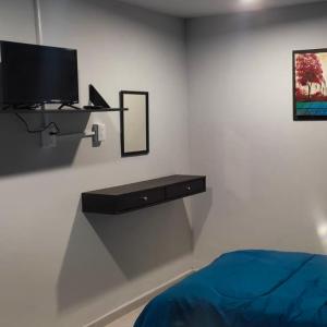 una camera con letto e TV a parete di El Hostalito Metepec a Toluca