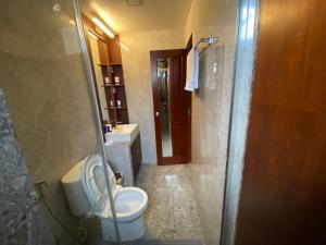 a bathroom with a toilet and a sink at Luxury 3 Room Apartment by Oboe in Male City