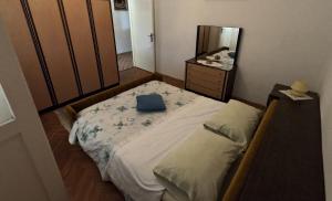 a small bedroom with a bed and a mirror at Apartment Mili - 50m from beach in Sutomišćica