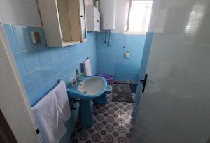 a blue bathroom with a sink and a toilet at Apartment Mili - 50m from beach in Sutomišćica