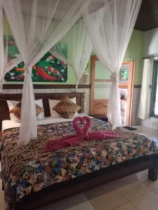 Postel nebo postele na pokoji v ubytování Putu Guest House Pemuteran