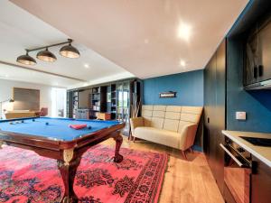 a living room with a pool table and a couch at Haven House in Lochgilphead