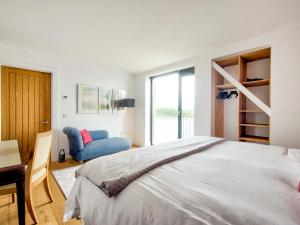a bedroom with a bed and a desk and a chair at Haven House in Lochgilphead