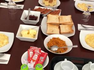 a table with many plates of food on it at Dream Stay Green in Nuwara Eliya