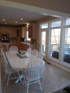 a kitchen with a white table and white chairs at Why Pay Outer Banks (OBX) Beach Prices? Sleeps 9+ in Columbia
