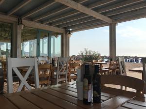 a table with bottles of wine sitting on top of it at Vila Elna in 2 Mai +25 photos