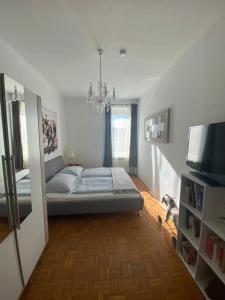 a bedroom with a bed and a television in it at Villa PetraBUNT in Villach