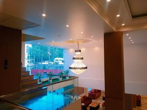 a lobby with a glass floor and a chandelier at KAREEM RESIDENCY in Srinagar