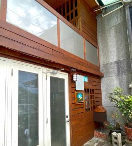 a front door of a house with a window at 寵物友善九份沐石原宿一館包棟民宿MU SHI BnB兩人即包棟 in Ruifang