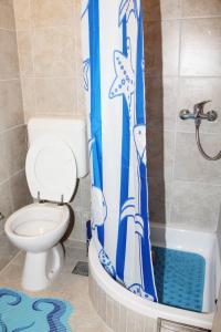 a bathroom with a toilet and a shower curtain at Apartment in the centre of Trogir in Trogir
