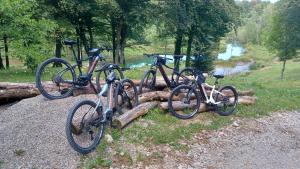 three bikes parked next to each other near a river at Yeti Cabin in Plitvica Selo +33 photos