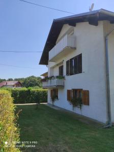 a white house with balconies and a yard at Home of nature - kuća prirode in Odžak