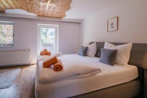 a bedroom with a large white bed with pillows at Kaiser Apartments in Scheffau am Wilden Kaiser