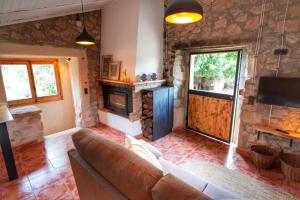 a living room with a couch and a fireplace at Serra de Martines in Batea