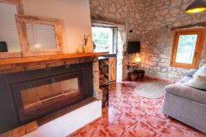 a living room with a fireplace and a couch at Serra de Martines in Batea