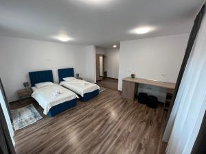 a large room with two beds and a desk at Aparthotel Plevnei4 in Cluj-Napoca