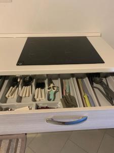 a drawer filled with lots of knives and other tools at I Platani 2 in Montecatini Terme