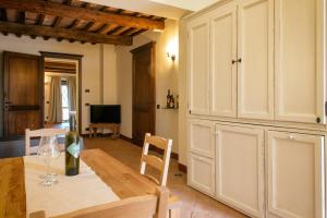 a kitchen with a table with a wine glass at Villaluce Wine Agriturismo in Castiglione del Lago