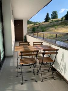 a group of tables and chairs on a balcony at Apartmán Pinus in Donovaly