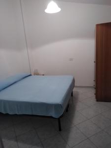 a bedroom with a bed and a wooden cabinet at Villa Stella in Praia a Mare