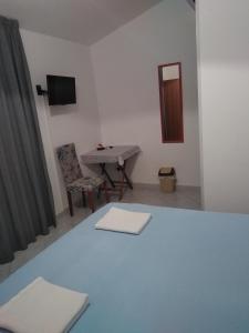 a room with a table and a chair and a mirror at Villa Stella in Praia a Mare