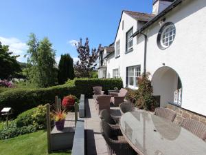 a patio with tables and chairs in front of a house at Moss Bank House in Conwy