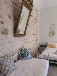 a bedroom with a mirror and a bed and a chair at Casa Con Vista Apartments in Halki