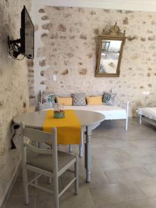 a dining room with a table and a mirror at Casa Con Vista Apartments in Halki