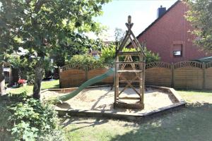 a playground with a slide in a yard at Feriendorf Öfingen 01 in Bad Dürrheim