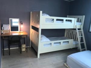 a bedroom with two bunk beds and a desk and a computer at Grim Garden Guesthouse in Yeosu