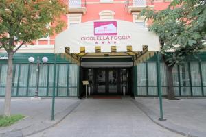 a building with a sign that reads googlucoco at Hotel Cicolella in Foggia