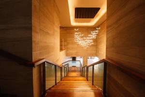 a hallway with wooden floors and a chandelier at Nouveau Resort in Mambajao