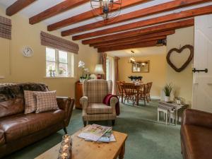 a living room with a couch and a table at Columbine Cottage in Ambleside