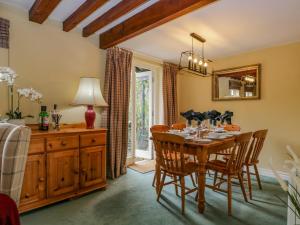 a dining room with a wooden table and chairs at Columbine Cottage in Ambleside +37 photos
