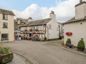 a group of people sitting outside of a building at Columbine Cottage in Ambleside