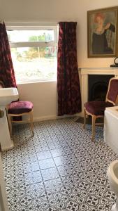 a living room with a fireplace and a window at 1 Laurel Cottages in Dawlish