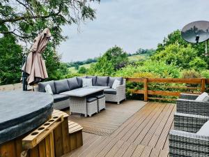 a patio with a couch and a table on a deck at Mountain View Lodge in Ludlow